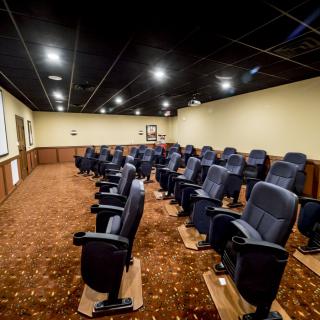 A spacious theater room with rows of comfortable seating.
