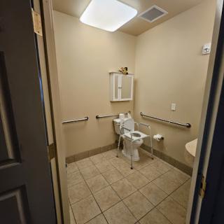 A spacious and accessible bathroom with modern fixtures.