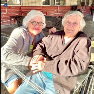 A joyful moment shared between an elderly couple, enjoying each other's company.