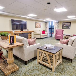 A cozy living room with comfortable seating, a large television, and stylish decor.