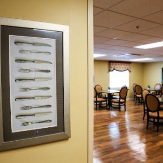 A decorated dining area featuring a unique display of forks on the wall.