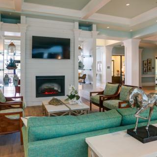 A modern living room with stylish furniture and a cozy fireplace.