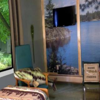 A cozy room with a nature-themed decor, featuring a chair, television, and a large window overlooking greenery.