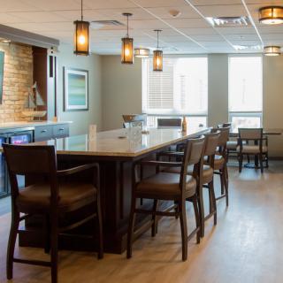 Modern bar interior with counter seating and ambient lighting.