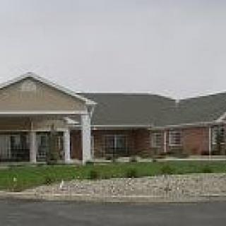 A suburban residential building with a landscaped front.
