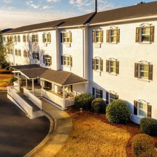 A large, elegant hotel building with classic architecture basking in the warm glow of sunset.