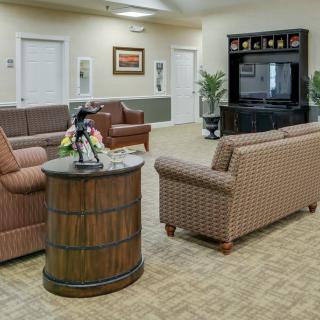 A cozy living room featuring comfortable sofas and a television.