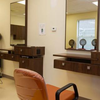 An empty beauty salon interior with chairs and mirrors.