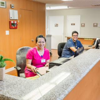 Reception staff at a welcoming office environment.