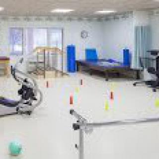 A well-equipped rehabilitation and physical therapy room with various exercise equipment.