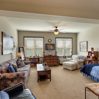 A cozy living room with comfortable seating and large windows.
