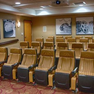 A well-designed presentation room featuring comfortable seating and ambient lighting, ideal for meetings and screenings.