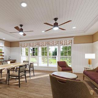 A cozy and well-lit living space featuring a dining table, comfortable seating, and large windows allowing for plenty of natural light.