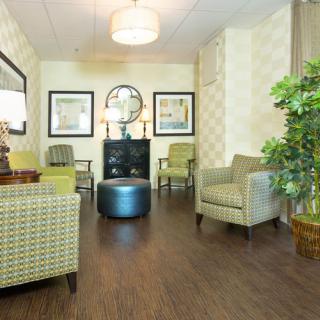 A cozy waiting room with seating and decorative elements.