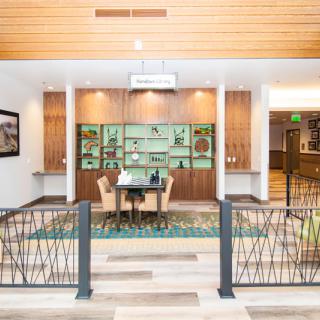 A modern lobby with a seating area and decorative wall display.