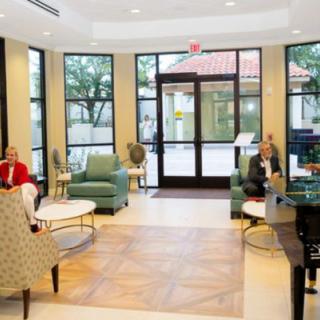 A modern lobby area with comfortable seating and people waiting.