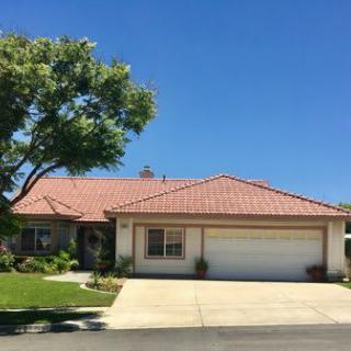 A suburban house with a two-car garage and a neatly maintained front yard.