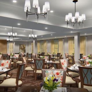 Elegant dining area with stylish chandeliers and beautifully set tables.
