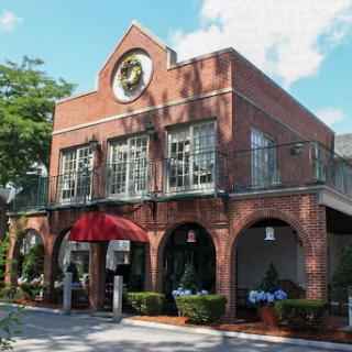 A charming brick restaurant featuring a welcoming outdoor dining area.