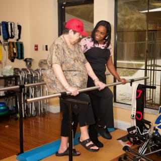 A patient receiving support during a rehabilitation exercise session.