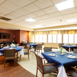 A cozy restaurant dining area with blue tablecloths and neatly set tables.