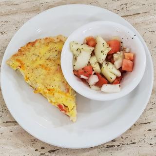 A plate with a slice of omelette and a bowl of vegetable salad.