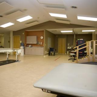 An indoor view of a physical therapy room equipped for rehabilitation exercises.
