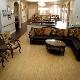 Spacious living room with elegant furniture and hardwood flooring.