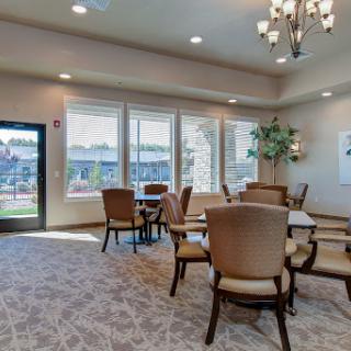A modern lounge area featuring comfortable seating, ample natural light, and a welcoming atmosphere.