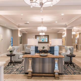 A spacious and elegantly decorated lobby area with modern furnishings and ambient lighting.