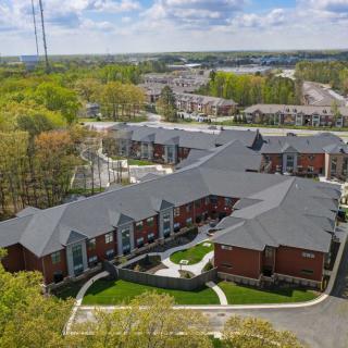 Aerial view of residential buildings surrounded by trees and greenery.