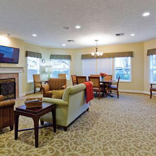A cozy living room with comfortable seating, a fireplace, and a television.
