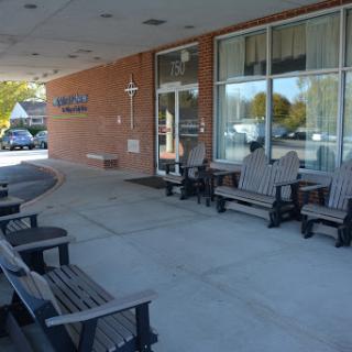 A welcoming outdoor seating area in front of a building.