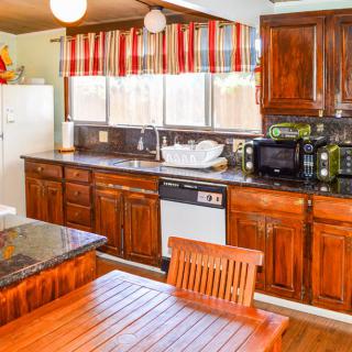A cozy kitchen with wooden cabinets and modern appliances.