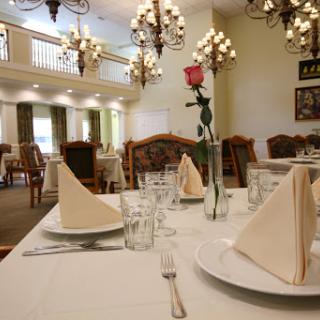 An elegant dining setting with a beautifully arranged table and chandeliers.