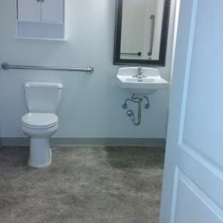 A view of a clean and modern bathroom with a toilet and sink.