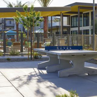 A modern outdoor recreational area featuring a table tennis setup and contemporary architecture.
