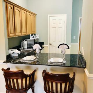 Cozy kitchen area with a granite countertop and seating.