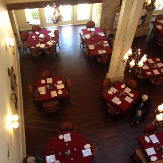 An overhead view of an elegant restaurant dining area with tables set for guests.