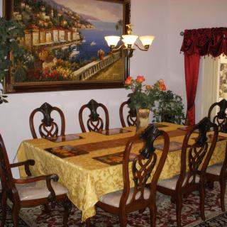 A well-decorated dining room with a table set for family gatherings.