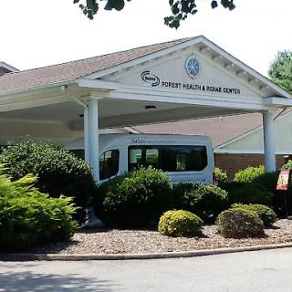 A view of a healthcare facility with well-maintained landscaping.