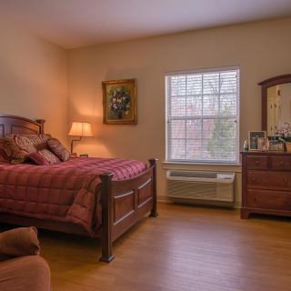 A cozy bedroom with wooden furniture and natural light.