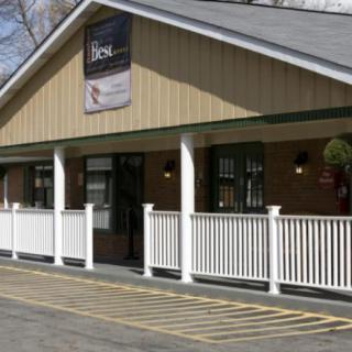 A restaurant building with a porch and signage on the front.