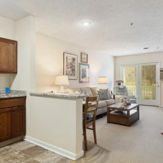 A cozy living space featuring an open floor plan with a blend of modern decor and warm lighting.
