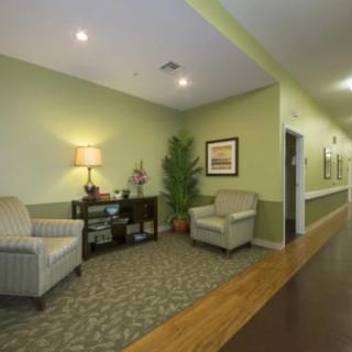 A cozy hallway with armchairs, a small table, and decorative elements.