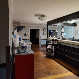 A view of a medical office reception area, featuring workstations and a calm atmosphere.