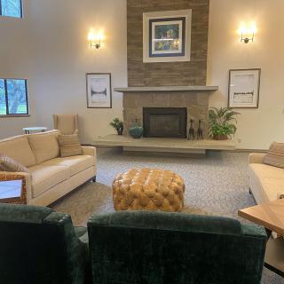 Cozy living room with a fireplace, modern sofas, and elegant decor.