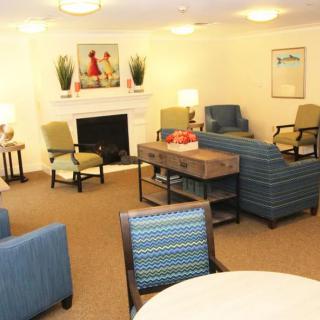 A cozy living room with comfortable seating and a fireplace adorned with decorative items.