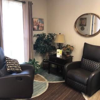 A cozy corner of a living room featuring comfortable seating and decorative elements.