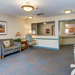 A cozy waiting area with comfortable seating and a reception desk.